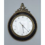 A 19th Century circular small wall clock, the enamel dial with Roman numerals, the pocket watch