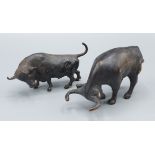 A bronze model of a bull, 10cm long, together with another bronze bull