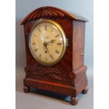 A William IV mahogany cased bracket clock with carved and shaped case,the circular enamel dial