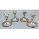 A set of 925 silver dwarf candlesticks with circular bases, 7.5cms tall
