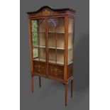 An Edwardian mahogany and painted display cabinet, with two astragal glazed doors raised upon square