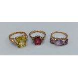 A 9ct gold Topaz set dress ring together with two other 9ct gold dress rings