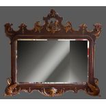 A 19th Century French large wall mirror, the pierced and gilded top with central carved figure of