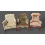 A Victorian walnut drawing room armchair together with two other armchairs