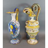 A Majolica jug with shaped handle, 38cms tall together with another similar Majolica jug