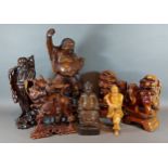 A Chinese carved hardwood figure on horse back together with four carved figures and pair of foo