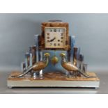 An Art Deco marble and stainless steel mantel clock mounted with models of two pheasants, the dial