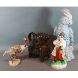 A USSR porcelain figure together with a Russian jug in the form of a goat, a model of a Parrot and a