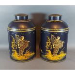 A pair of Toleware cannisters with Chinoiserie decoration on a navy blue ground, 36cms tall