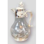 A silver plated and engraved glass claret jug, engraved with grape vine, the cover with Lion and