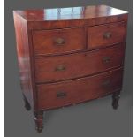 A 19th Century mahogany bow fronted chest of two short and two long drawers with brass handles