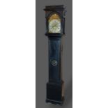 An ebonised longcase clock, the arched hood above a rectangular door and conforming plinth base, the