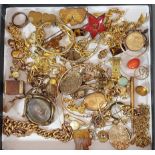 A collection of gold plated jewellery to include charms, lockets and brooches