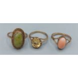 A 9ct gold ring set oval Citrine together with two other 9ct gold dress rings, one set coral, the