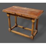 An oak small refectory drawer leaf dining table with a moulded frieze raised upon turned legs with