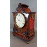 A William IV mahogany case bracket clock, the carved shaped case with side ring handles, the dial