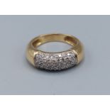 An 18ct yellow gold band ring encrusted with diamonds, ring size L, 5.9gms