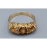 An 18ct gold ring set with three Citrine interspaced with four diamonds 5.1gms, ring size P