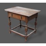 A 19th Century oak lowboy, the moulded top above a frieze drawer and raised upon turned legs with