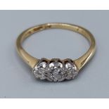 An 18ct gold three stone diamond ring, 2.3gms, ring size L