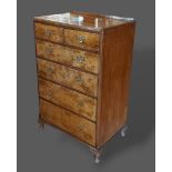 A Circa 1920's Queen Anne style walnut chest of two short and four long drawers with brass handles