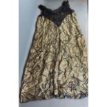 A gold thread and black lace dress together with a beaded and lace work shawl