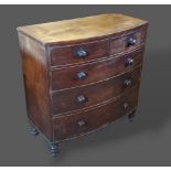 A Victorian mahogany bow fronted chest of two short and three long drawers with knob handles