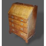 A George II walnut bureau, the fall front enclosing a fitted interior above four long drawers with