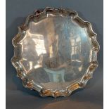 A George V silver salver of shaped outline with three scroll feet, London 1920, 16ozs, 25.5cms