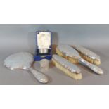 A Birmingham silver backed four piece dressing table set together with a Sheffield silver napkin