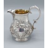 A Victorian silver cream jug with embossed and engraved decoration, London 1862 maker Richard Sibley