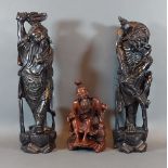 A pair of Chinese root carvings of figural form, 35.5cms tall together with another similar smaller,
