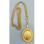 A Victorian oval locket together with a long guard chain