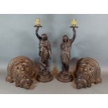 A pair of patinated spelter table lamps in the form of classical figures with wall bracket mounts,