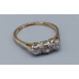 An 18ct gold three stone diamond ring, claw set, 2.2gms, ring size L