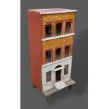 A three story dolls house, together with a small amount of dolls house furniture, 46.5cms wide,