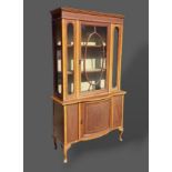 An Edwardian mahogany satinwood banded display cabinet, the moulded cornice above two astragal
