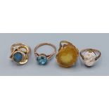 A gold dress ring set oval opal, (marks rubbed) together with three yellow metal dress rings