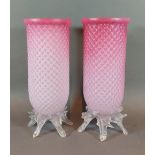 A pair of early 20th Century pink glass storm vases with naturalistic clear glass bases, 24cms tall
