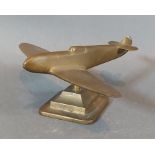 A WWII brass model of a Spitfire, 5.5cms tall