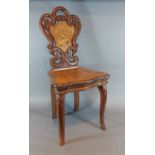 A 19th Century swiss marquetry inlaid musical childs chair, with a pierced back above a moving