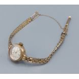 A 9ct gold ladies wristwatch by Record with 9ct gold strap, 12.5gms