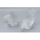 A Lalique glass paperweight in the form of a bird together with another similar Lalique glass