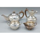 A George V silver four piece tea service comprising teapot, hot water jug, two handled sucrier and