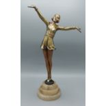 An Art Deco patinated metal figure in the form of a dancing girl, 37cms tall
