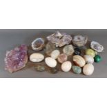 A collection of stone hand warmers in the form of eggs together with other related items