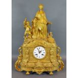 A 19th Century French ormolu mantle clock with figural surmount, the enamel dial with Roman numerals