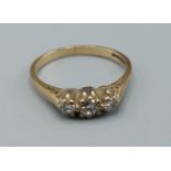 A 9ct gold three stone diamond ring, ring size L, 1.7gms