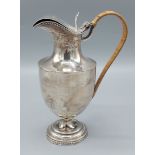 A Victorian silver jug with wicker handle, London 1898, 8ozs