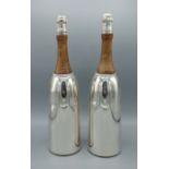 A pair of silver plated and wooden cocktail shakers in the form of champagne bottles, 37cms tall